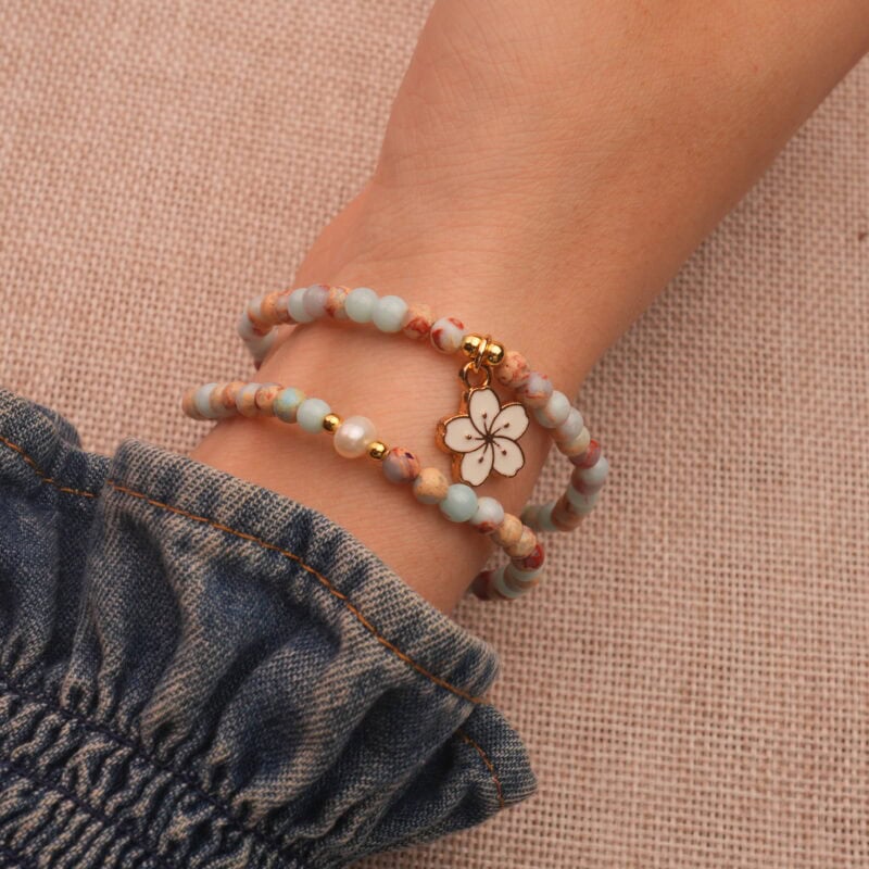 Elegant pearl bracelet layered on wrist, styled with a light outfit