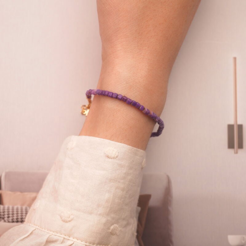 The 2mm amethyst and chalcedony bracelet worn on a wrist, showcasing its adjustable and minimalist design.