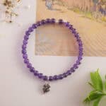 Amethyst bracelet placed naturally in a peaceful setting with soft ambient light