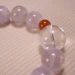 Close-up of transparent quartz beads and soft purple amethyst