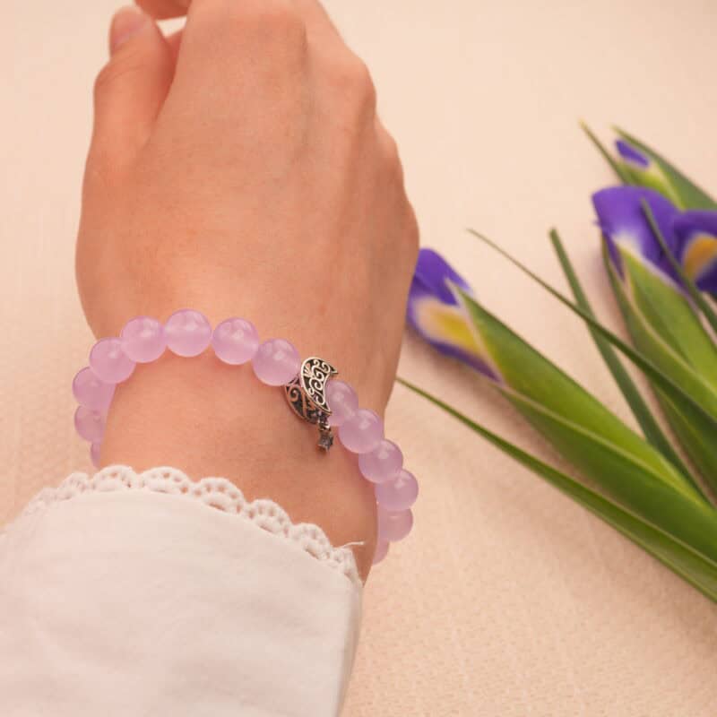 Model wearing the bracelet on wrist, suggesting evening relaxation or meditation