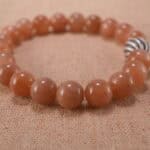 Close-up of the smooth peach moonstone textures and natural shimmer