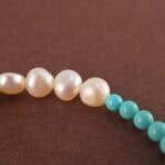 Close-up of turquoise and pearl beads on bracelet