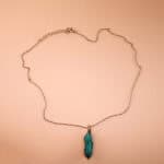 Handmade turquoise point pendant on a clean, white or soft neutral background