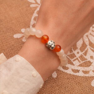 Worn on wrist, showing elegant 8mm beads and heart charm in focus