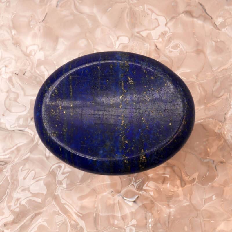 Polished Lapis Lazuli worry stone on white or neutral background