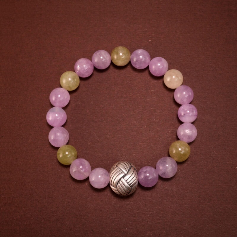 Kunzite and Prehnite healing crystal bracelet on white background