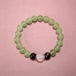 Prehnite, Moonstone & Obsidian 8mm gemstone bracelet on white background