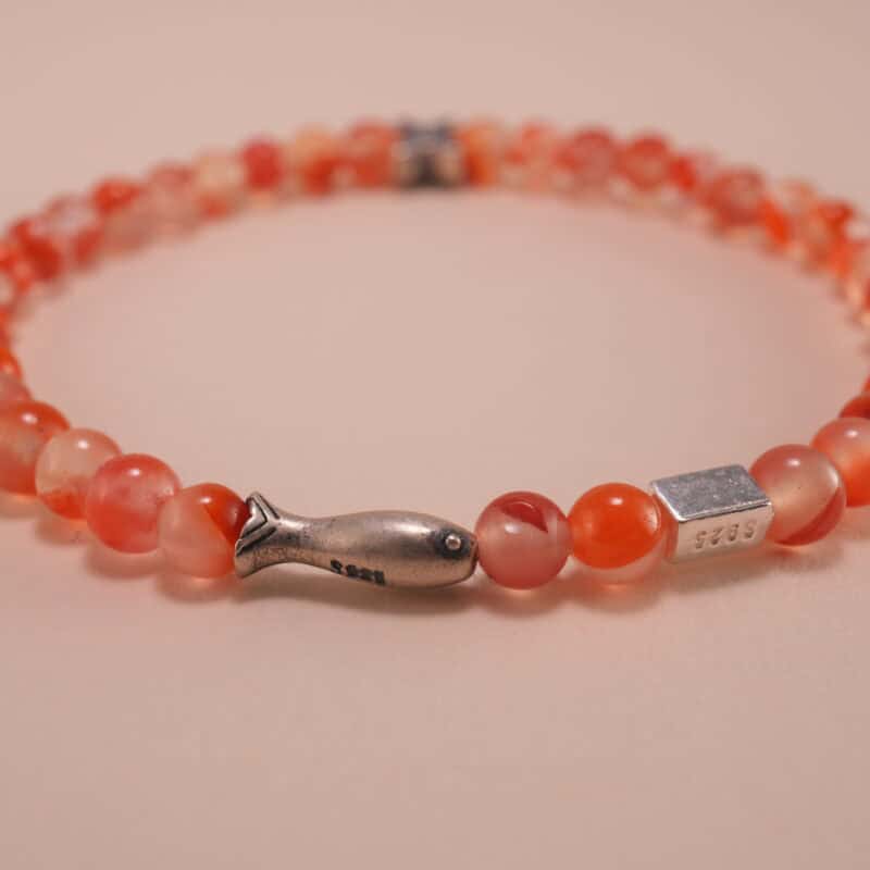 Close-up of carnelian beads and silver detailing on 4mm bracelet