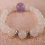 Close-up of polished white agate and amethyst beads with sterling silver clasp
