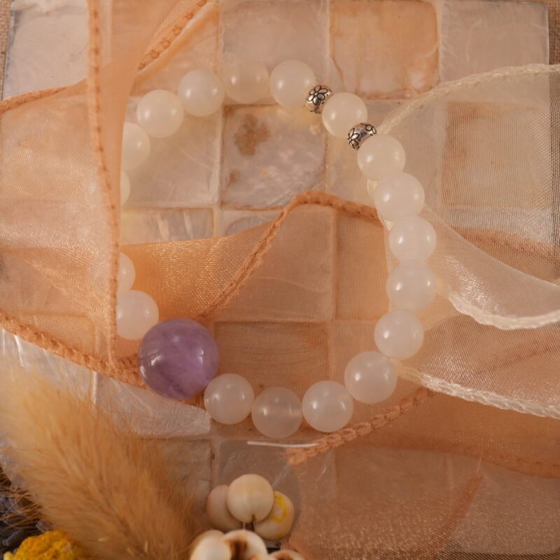 White agate and amethyst bracelet styled with natural elements and soft lighting