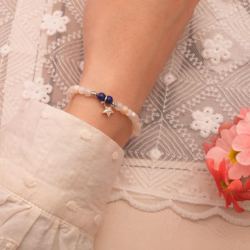 Model wearing the 8mm chalcedony and apatite bracelet with heart charm