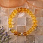 ：Bracelet placed near flowers to reflect earthy strength