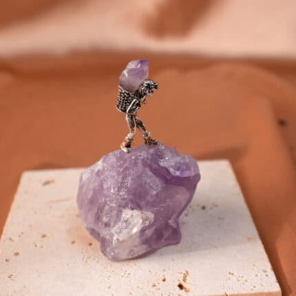 Close-up of Amethyst raw cluster in miner’s basket, showing crystal points
