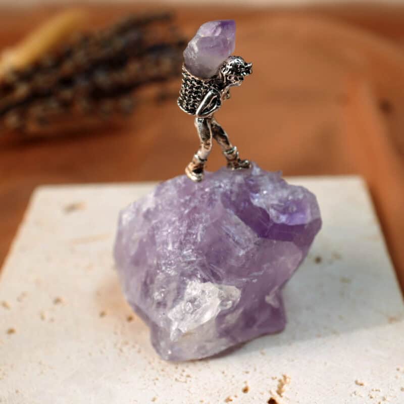 Close-up of Amethyst raw cluster in miner’s basket, showing crystal points