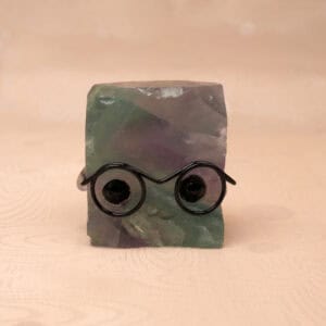 Natural Fluorite hedgehog figurine with multicolor tones on white background