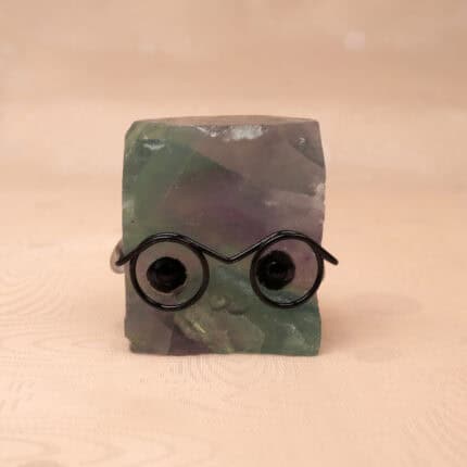 Natural Fluorite hedgehog figurine with multicolor tones on white background