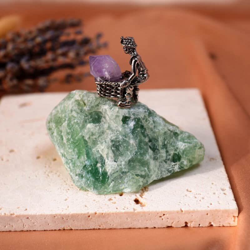 Fluorite crystal miner figurine with raw stone basket