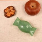 natural-green-onyx-candy-figurine-03-scaled.jpg" alt="Natural Green Onyx Candy Figurine displayed in natural light, showing its rich green color and smooth polished surface