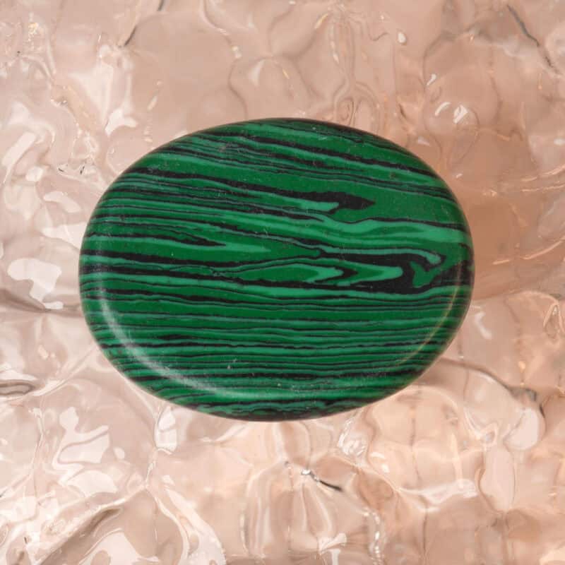 Natural Malachite worry stone with vibrant green bands and smooth surface