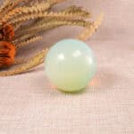 Close-up of the opal sphere showing iridescent colors and surface details