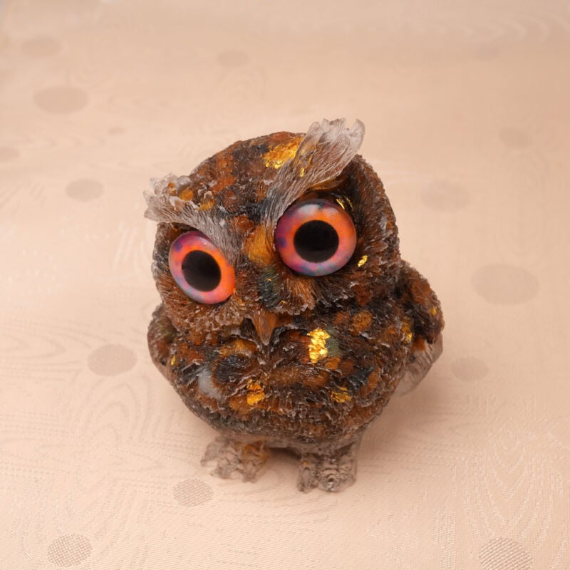 Close-up of Tiger Eye owl showing chatoyant (cat's eye) effect and carved detail