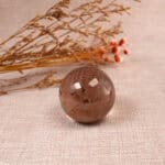 Smoky Quartz crystal ball placed on a meditation altar or beside healing tools