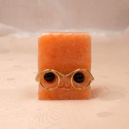 Hand-carved Sunstone hedgehog figurine on a white background