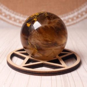 Polished Tiger Skin Smelting Quartz crystal sphere on a display stand