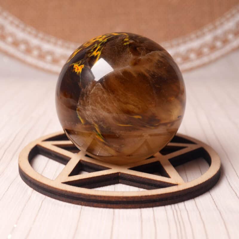 Polished Tiger Skin Smelting Quartz crystal sphere on a display stand