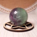 Watermelon Fluorite crystal sphere showing vivid green and pink tones on a clear stand