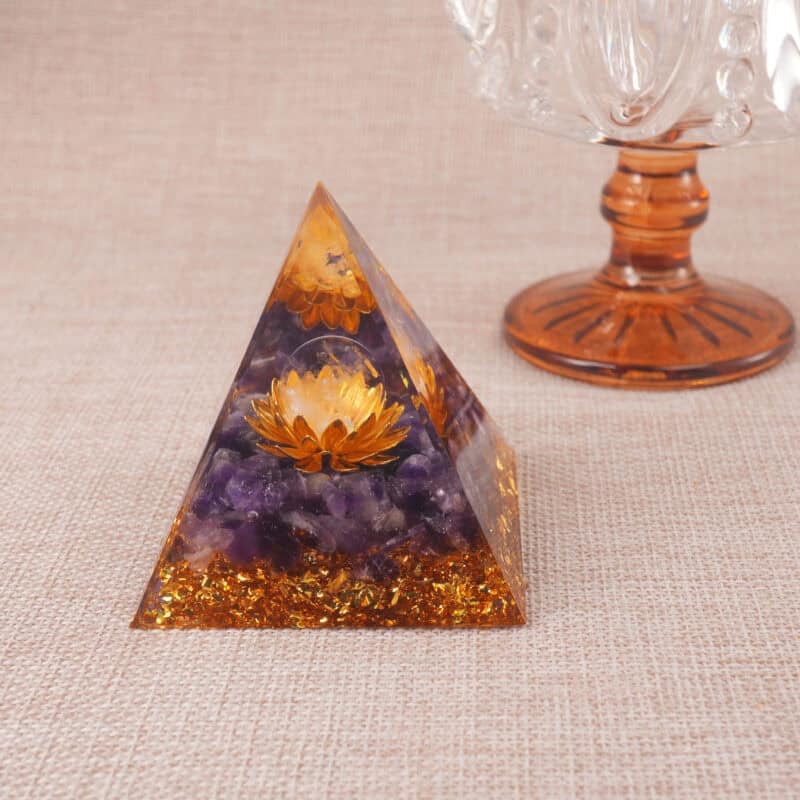 Purple lotus resin pyramid placed in a meditation space with glasses