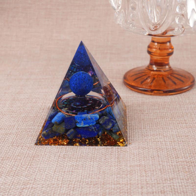Close-up of Lapis Lazuli resin pyramid showing blue stone chips and shimmering gold foil inside
