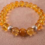 Close-up of polished Tiger Eye and Azeztulite beads showing golden chatoyancy