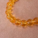 Close-up of polished Tiger Eye and Azeztulite beads showing golden chatoyancy