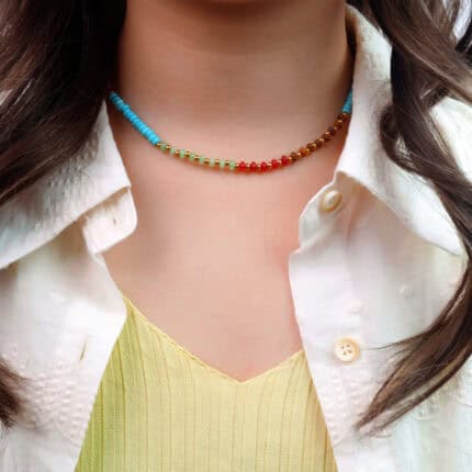 Model wearing Tibetan turquoise and chalcedony necklace with earthy-toned outfit