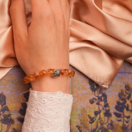 Citrine bracelet worn on wrist, reflecting natural sunlight