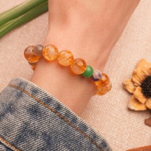 Vibrant multi-gemstone bracelet worn on wrist in daylight