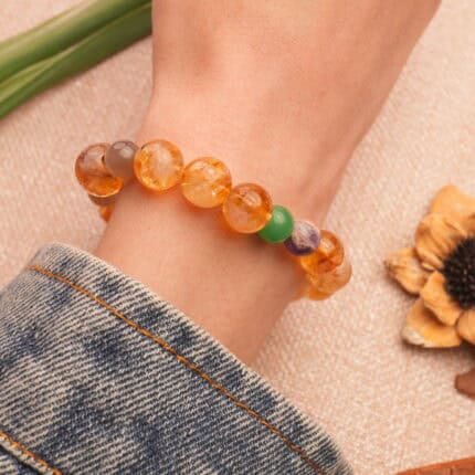 Vibrant multi-gemstone bracelet worn on wrist in daylight
