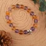 Ametrine bracelet in natural light with gradient purple-yellow hues.