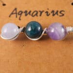 Close-up of Aquarius necklace showing amethyst, blue apatite, and aquamarine beads.