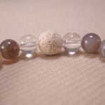 Close-up of blue heart agate bracelet with quartz and lava stone.