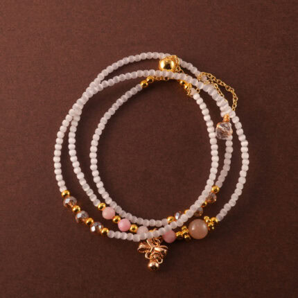 Multi-use necklace crafted with Cat's Eye and Rhodochrosite beads, styled as a wrap bracelet.