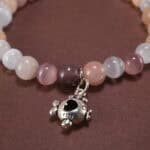 Close-up of cat’s eye and strawberry quartz bracelet with silver.