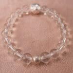 Close-up of clear quartz bracelet with S925 silver details.