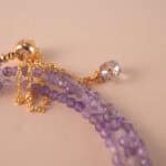 Close-up of polished amethyst beads and clasp detail, revealing the gemstone’s natural clarity and craftsmanship.