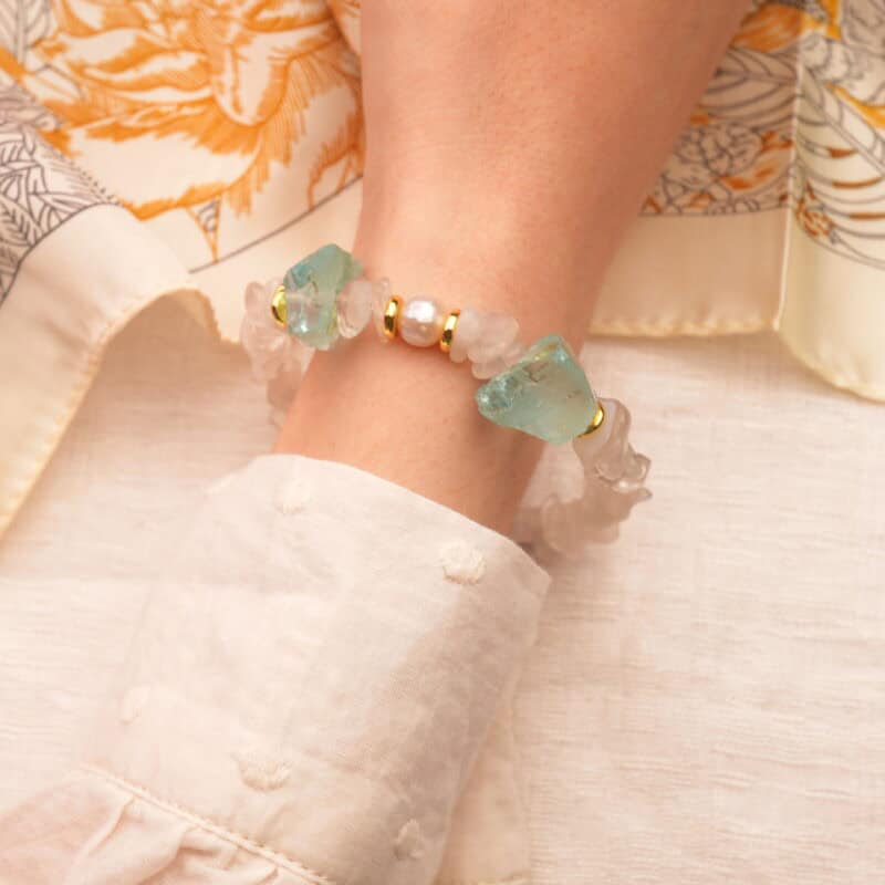 Gemini zodiac bracelet worn on the wrist, radiating a soft, luminous energy with an airy feel.