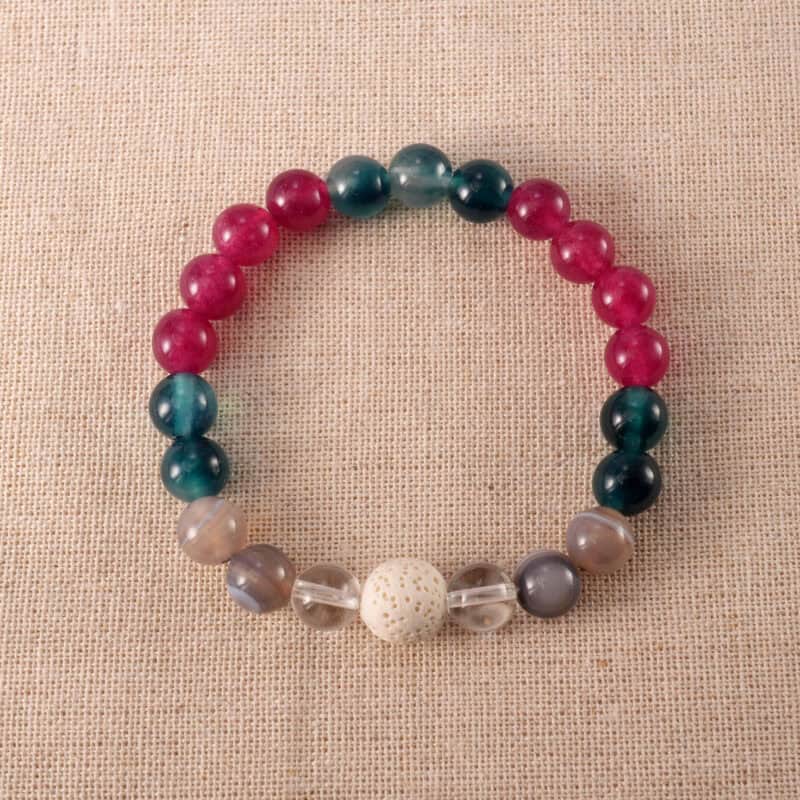 Handmade bracelet featuring lava stone, blue chalcedony, banded agate, and clear quartz – calming and grounding crystal design.