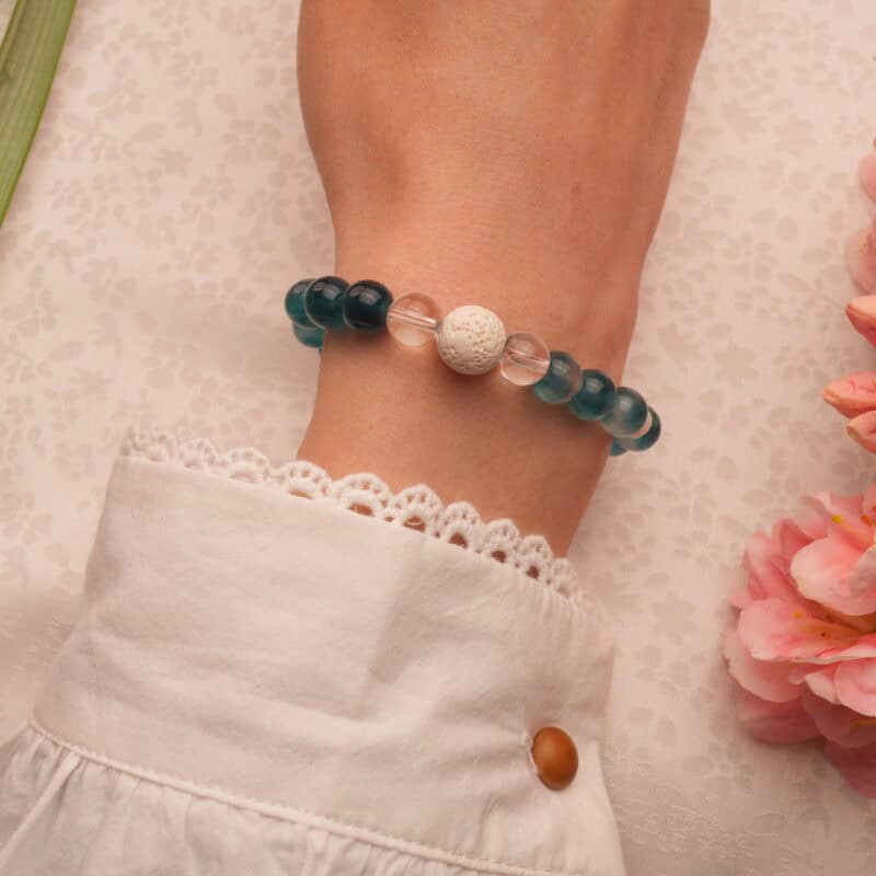 Wrist shot of handmade lava stone, chalcedony, pearl, and quartz bracelet – natural elegance on the wrist.