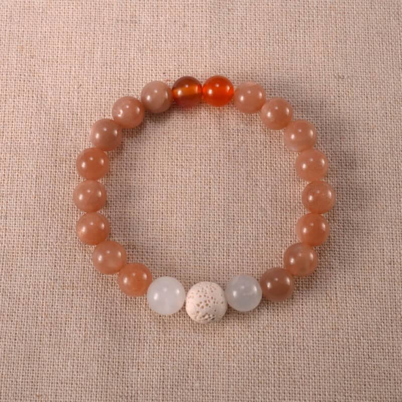 Handmade bracelet with lava stone, carnelian, white chalcedony, and peach moonstone – a blend of warmth and grounding energy.